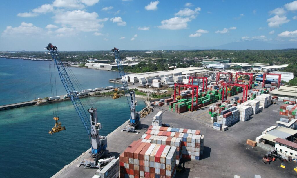 Aerial view of the KTC terminal with mobile harbor cranes on the berth and the container yard behind